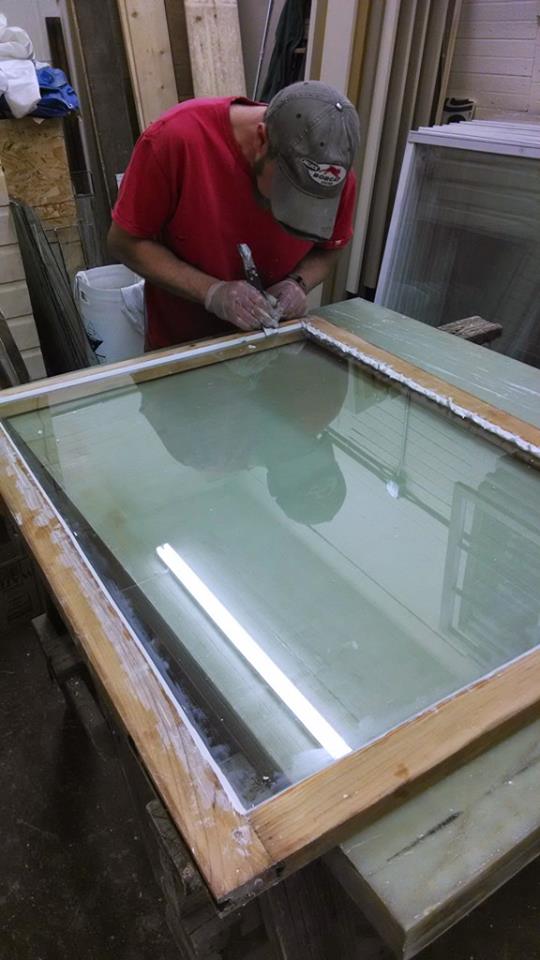 Installing the glazing on a historic window sash restoration.