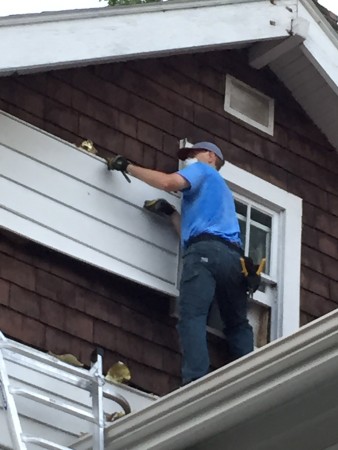 Removing the siding from the Marrons' house.